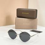 Sunglasses with gold-tone frame and dark round lenses