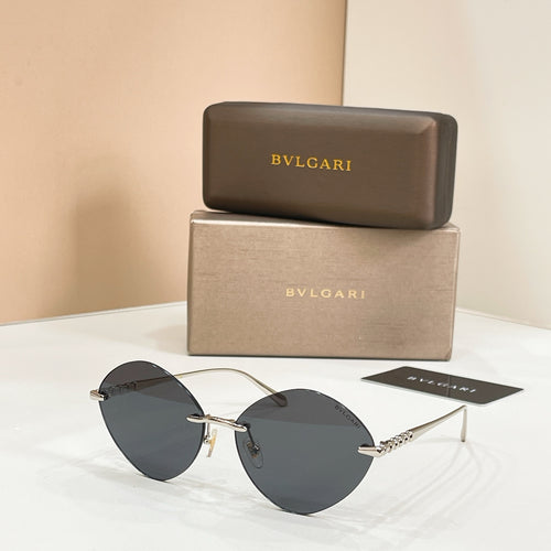 Sunglasses with gold-tone frame and dark round lenses
