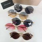 Assorted sunglasses with gold-tone frames and tinted round lenses