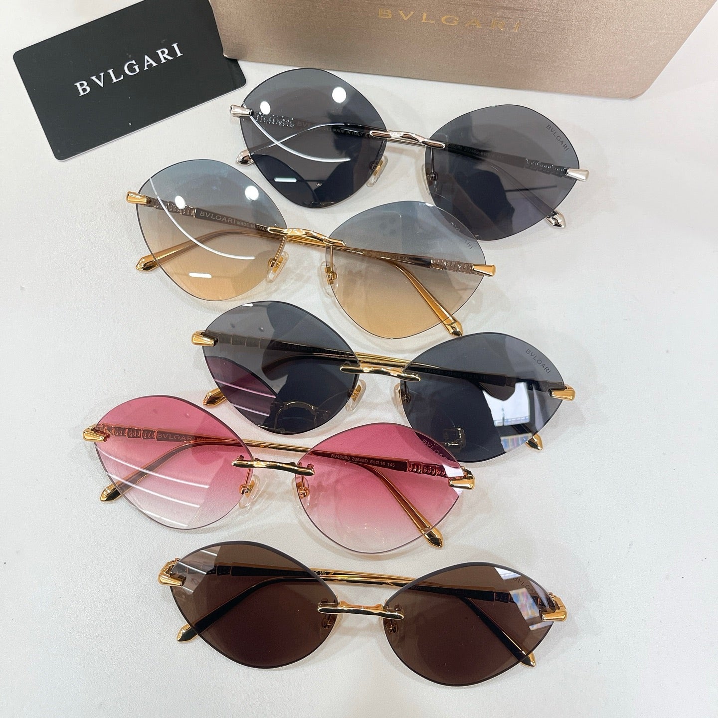 Assorted sunglasses with gold-tone frames and tinted round lenses