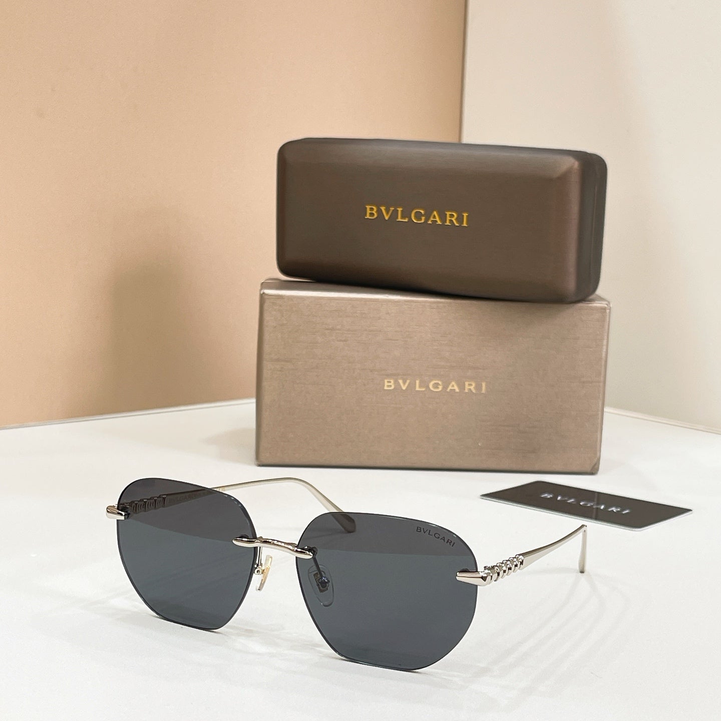 Round Bvlgari sunglasses with dark lenses and gold-tone frames