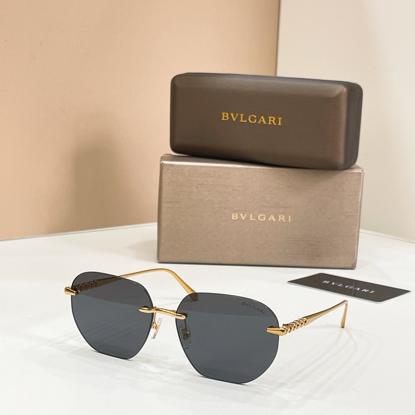 Round Bvlgari sunglasses with dark lenses and gold-tone frames