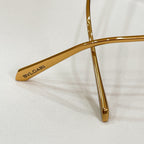 Gold Bvlgari sunglasses frame arm with logo text