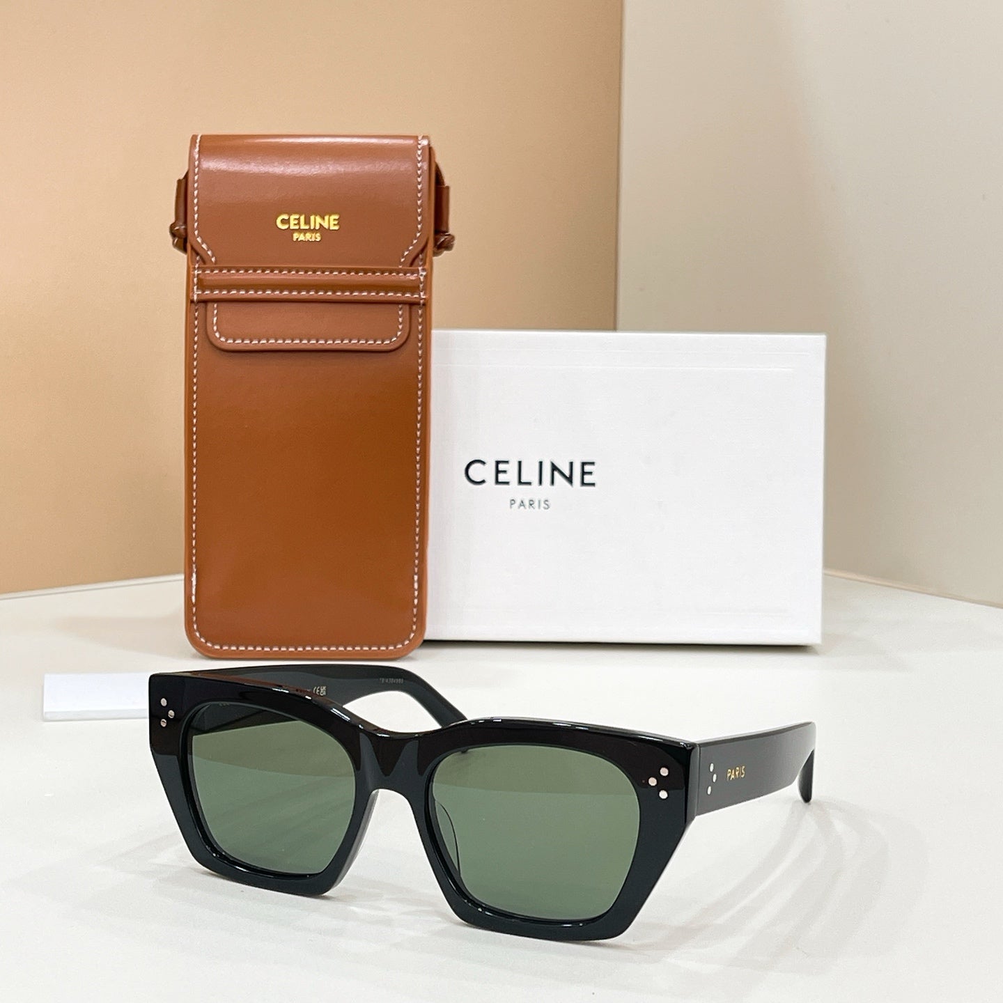 Celine sunglasses with square black frames and green tinted lenses
