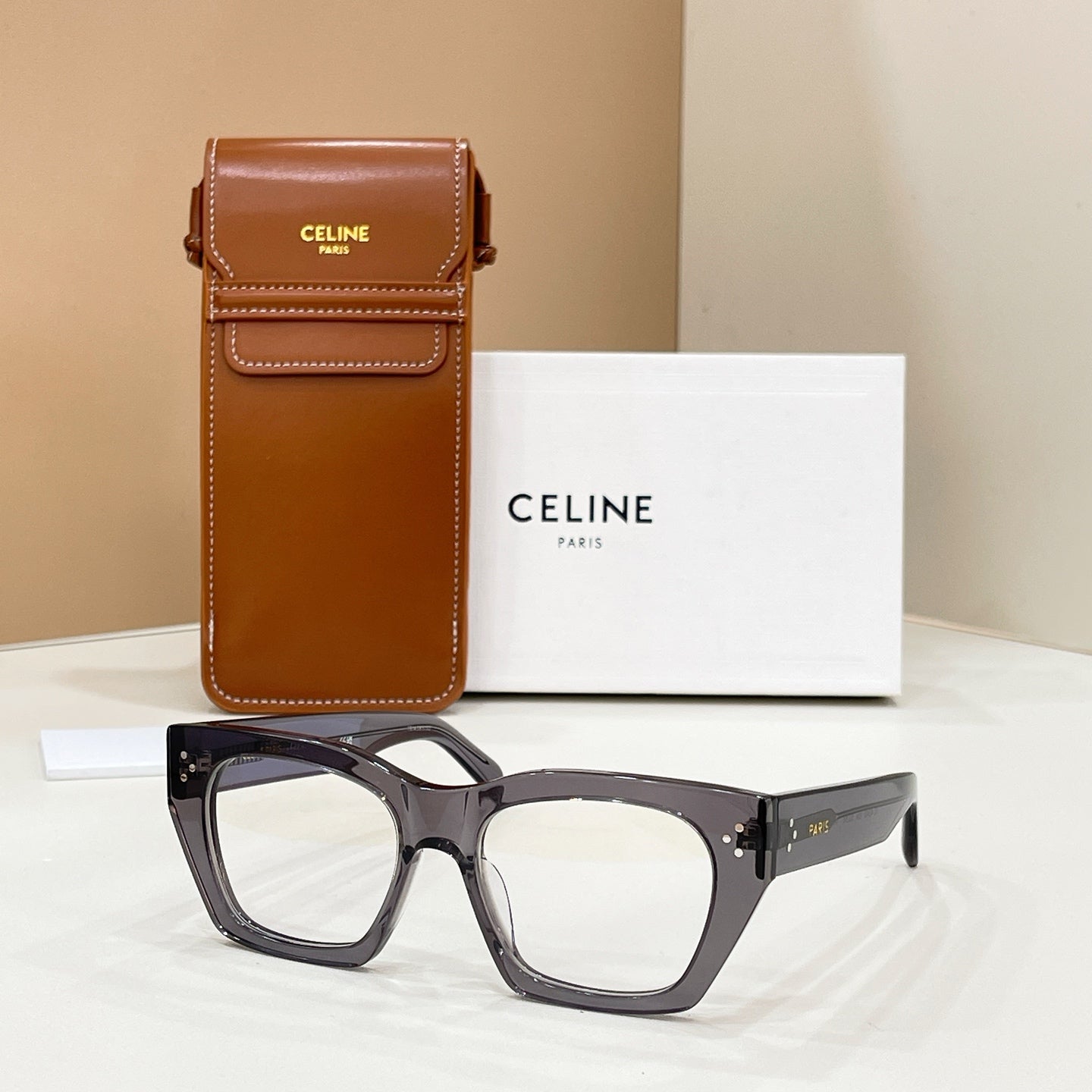 Celine glasses with dark square frames and clear lenses, angled front view.