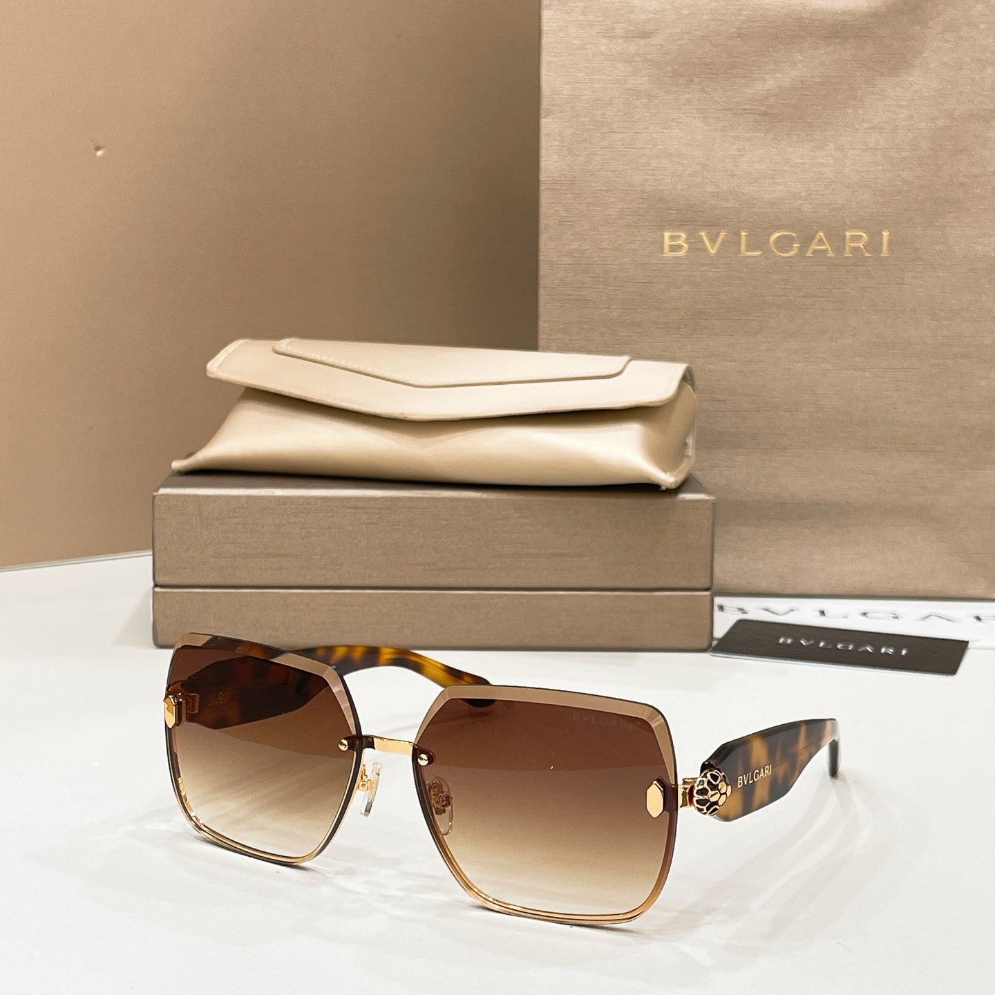 Bvlgari sunglasses with tortoise frame and brown tinted lenses, gold accents