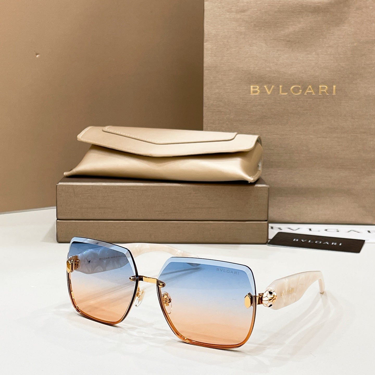 Bvlgari sunglasses with light blue tinted lenses and gold details, tortoise arms