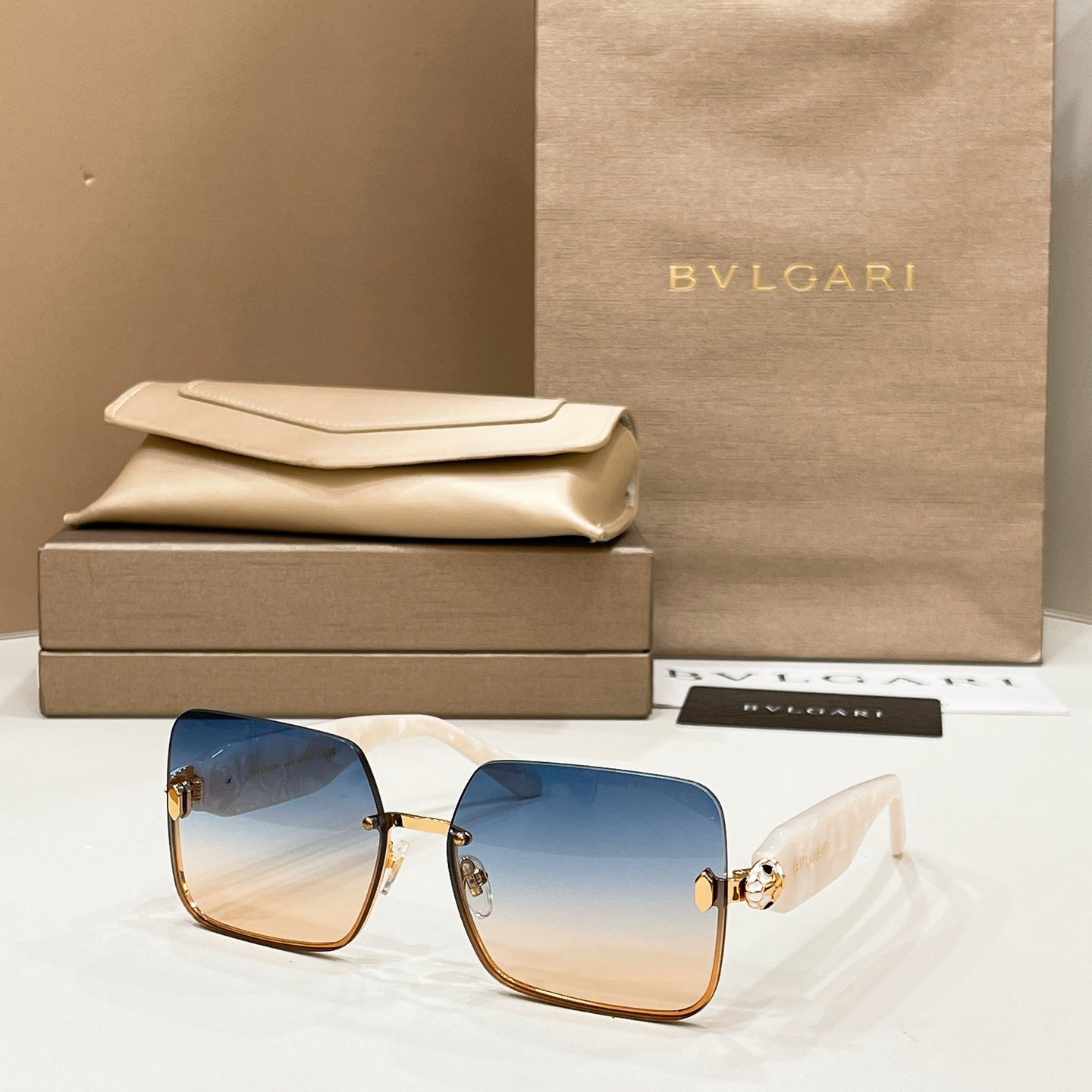Bvlgari square sunglasses with blue lenses and gold-tone metal frame