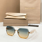 Bvlgari sunglasses with sky-blue lenses, gold accents, and tortoiseshell rims