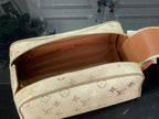 Louis Vuitton monogram bag opened to show tan-lined interior storage compartments