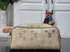 Louis Vuitton monogram canvas bag with tan leather handle and top zip closure