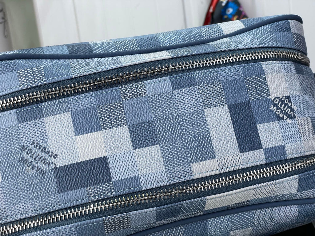 Checkered blue-and-white toiletry bag close-up of gold-tone zipper