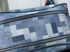Checkered blue-and-white toiletry bag close-up of gold-tone zipper