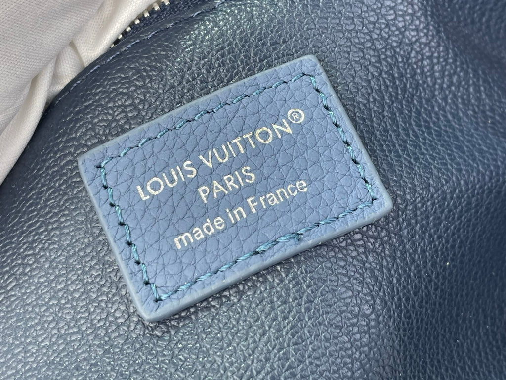 Blue leather label reading Louis Vuitton Paris made in France