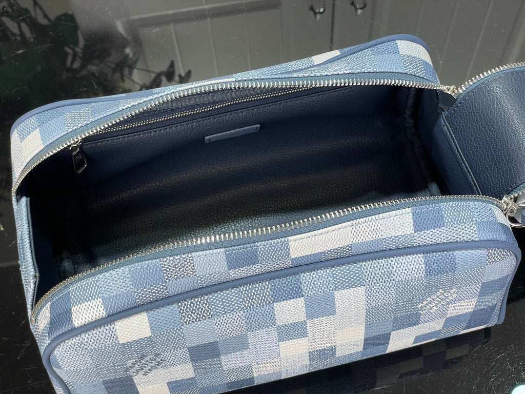 Checkered blue-and-white toiletry bag open with black interior and zip top