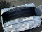 Checkered blue-and-white toiletry bag open with black interior and zip top