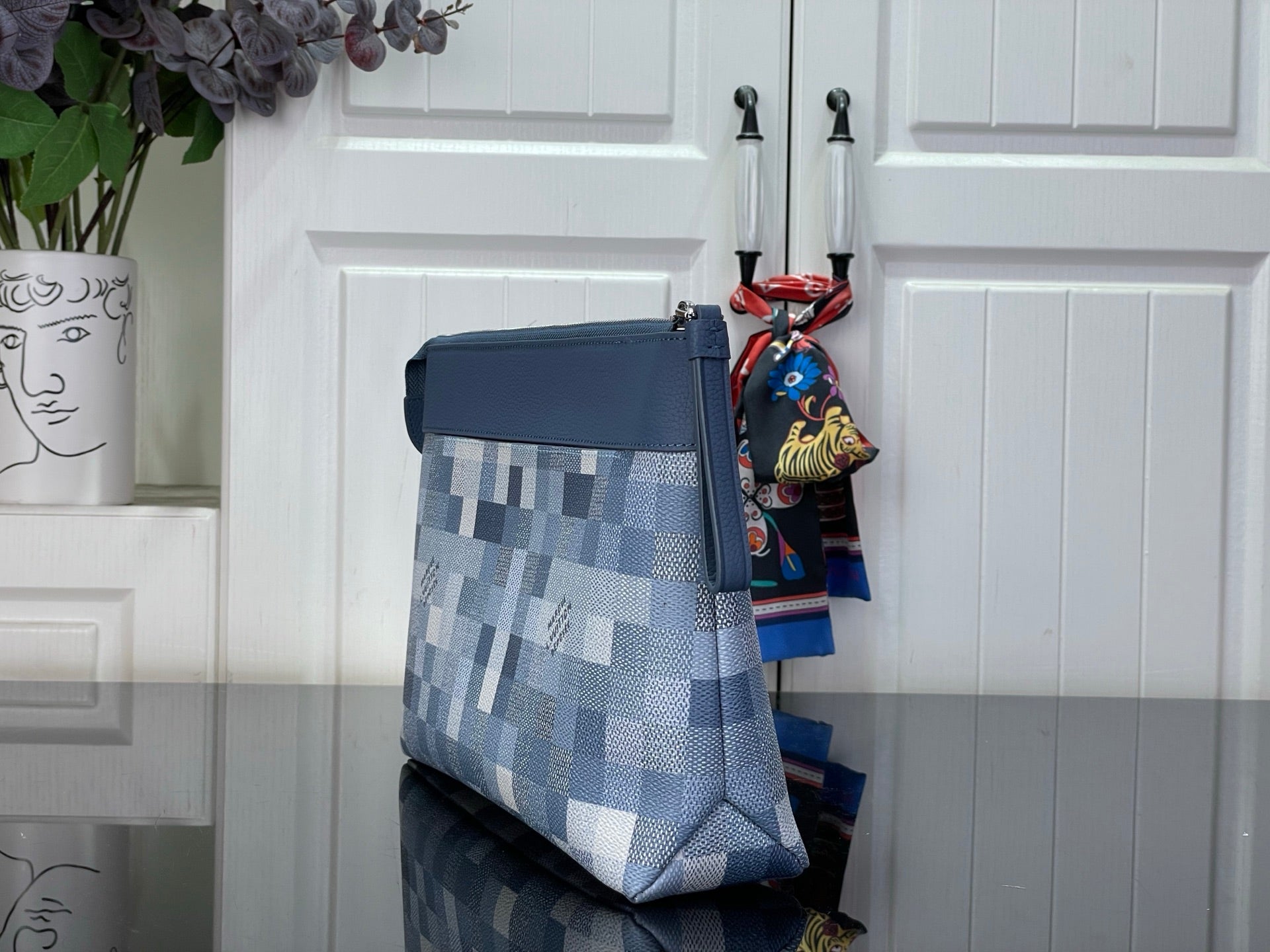 Blue Damier-check crossbody pouch with flat strap and zipper pull