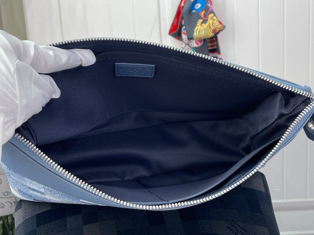 Blue zip pouch interior with fabric lining and metal zipper edge