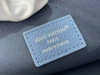 Blue leather tag inside zip pouch reading 'Louis Vuitton' and 'Made in France'