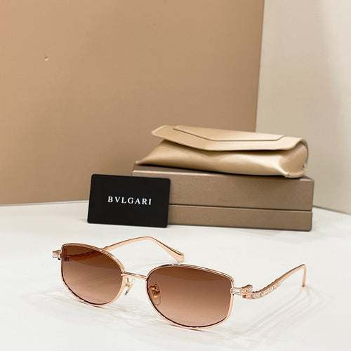 Gold-tone sunglasses with brown lenses, shown with beige case