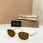 Gold-tone sunglasses with dark lenses, shown with beige case