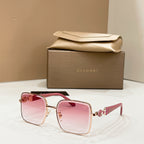 Gold-tone square sunglasses with pink tinted lenses and jeweled side detail