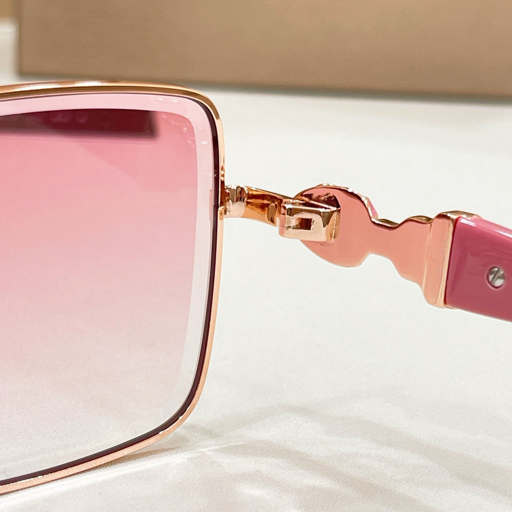 Pink square sunglasses close-up showing gold hinge and pink temple arm
