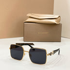 Gold-tone square sunglasses with dark blue lenses and jeweled side detail