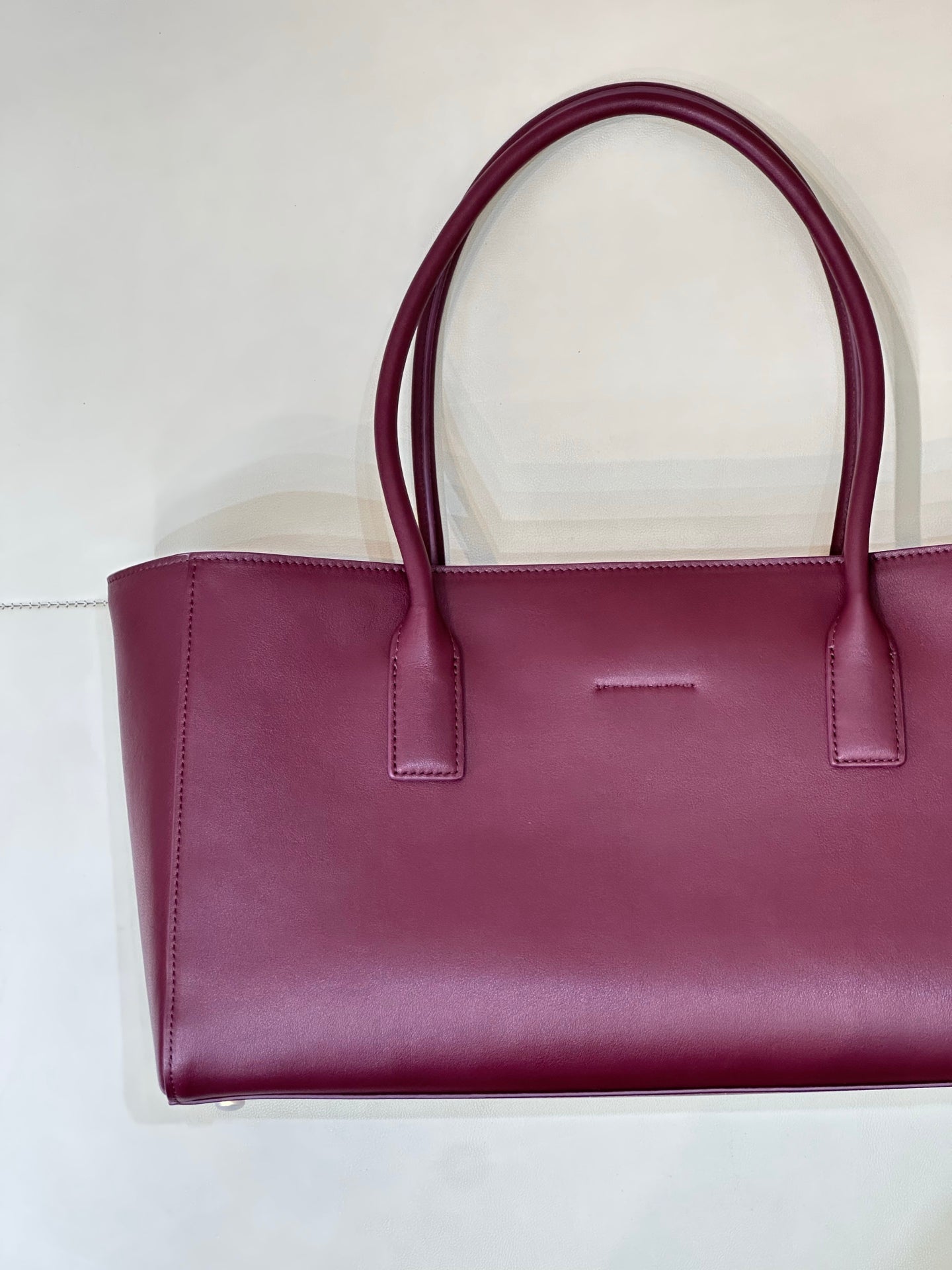 Chanel burgundy leather tote bag front view with top handles