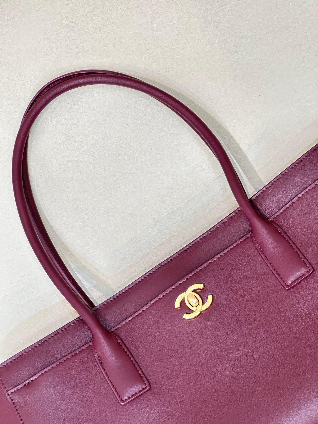 Chanel burgundy leather tote bag with CC logo and top-handle close-up