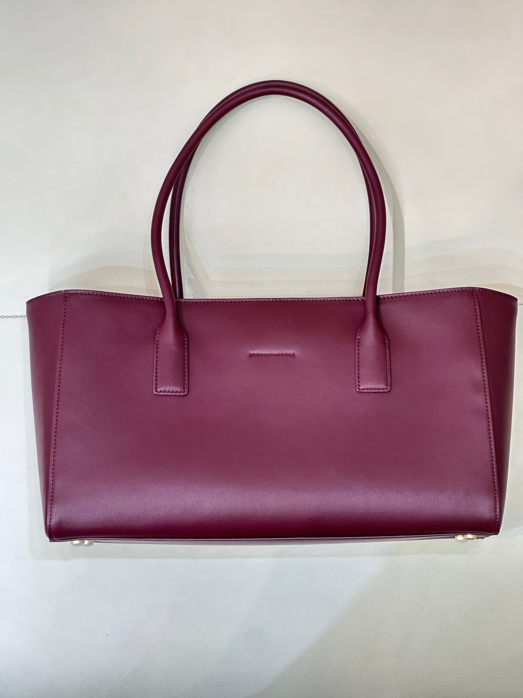 Chanel burgundy leather tote bag with top handles and center tab