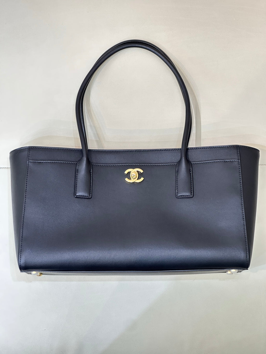 Navy Chanel leather tote bag with gold CC logo and two top handles