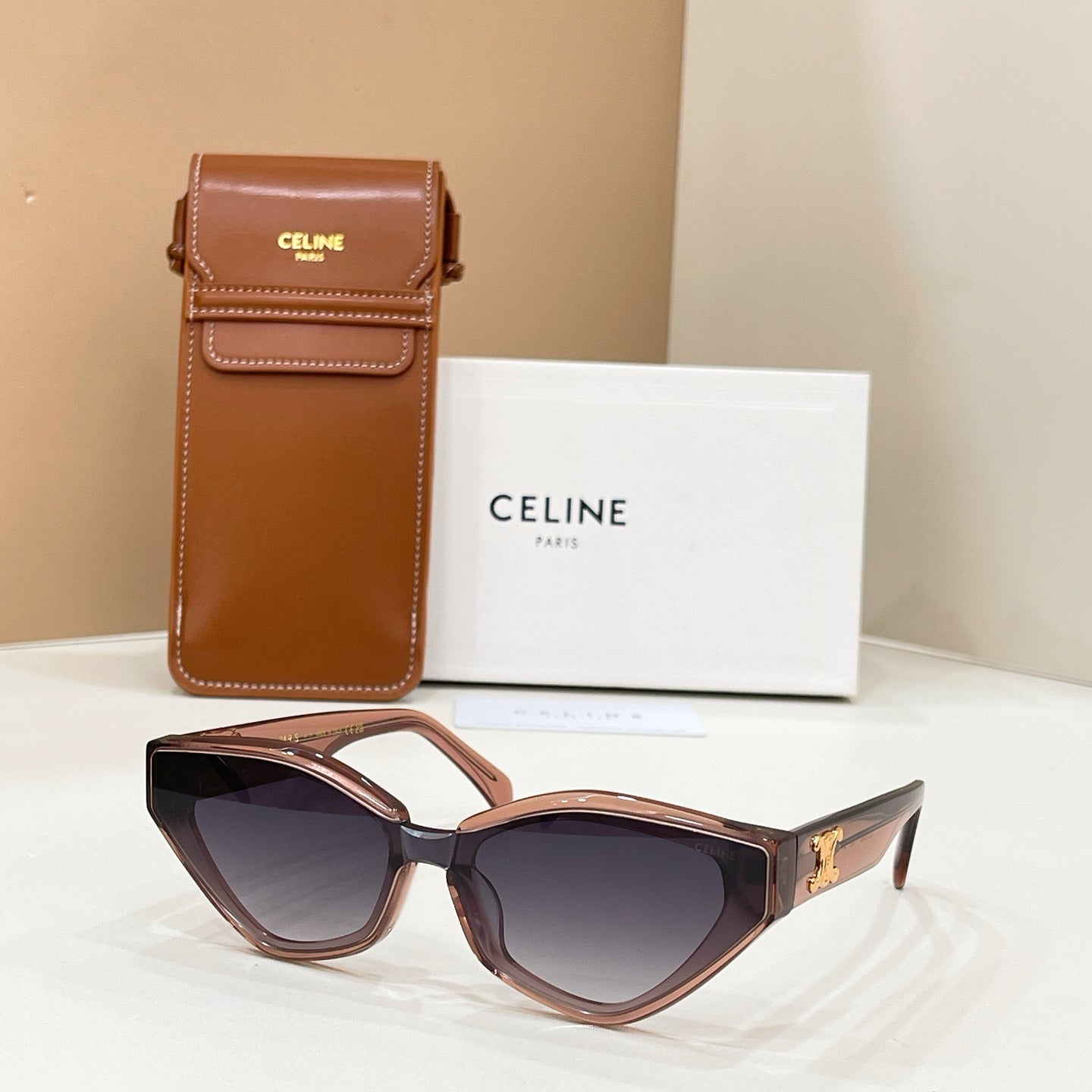 Celine brown cat-eye sunglasses with gold logo on temples and tinted lenses