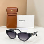 Celine dark cat-eye sunglasses with gold logo on temples and tinted lenses