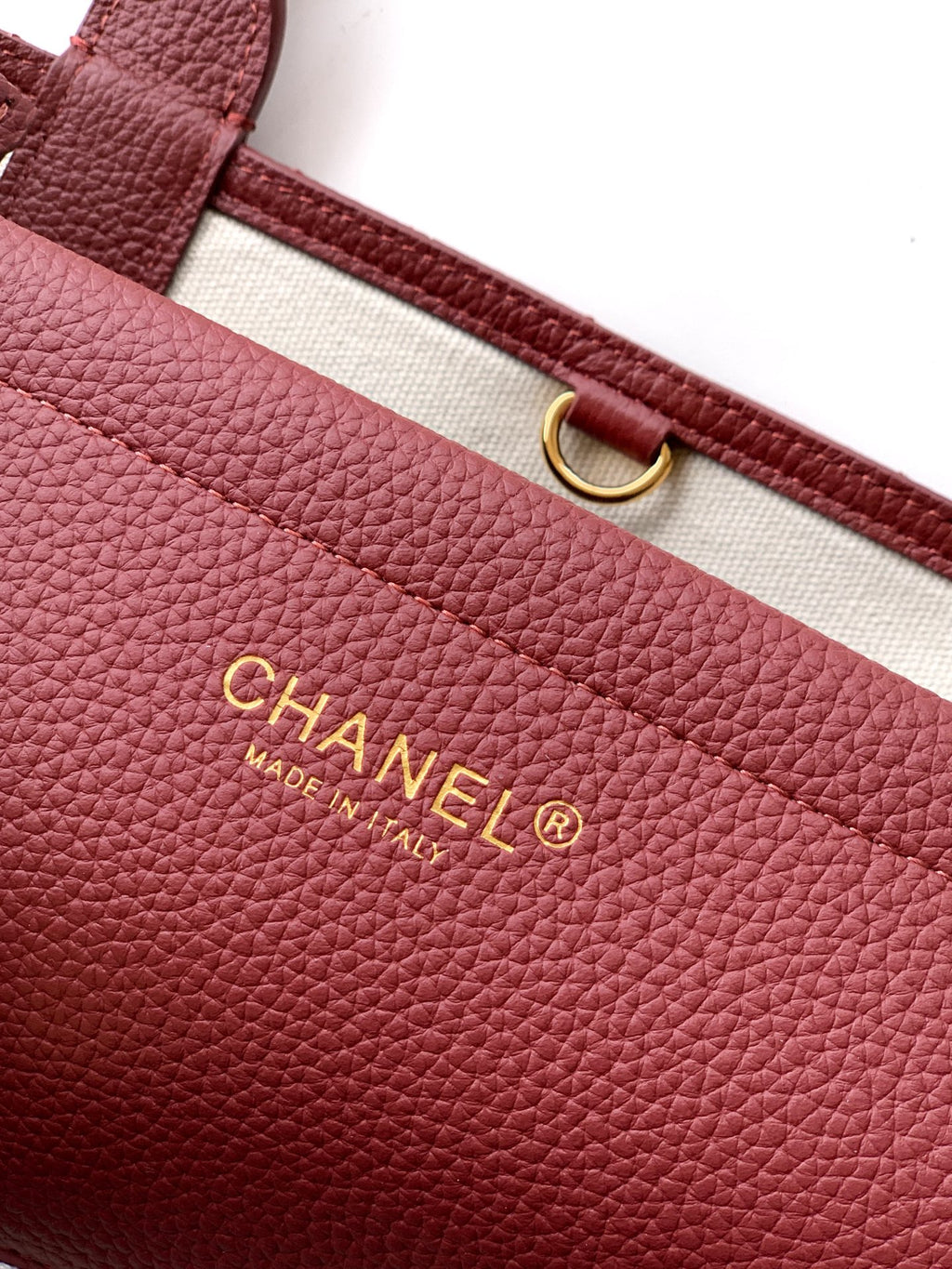 Burgundy Chanel handbag with gold “CHANEL MADE IN FRANCE” logo plate