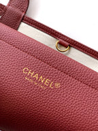 Burgundy Chanel handbag with gold “CHANEL MADE IN FRANCE” logo plate