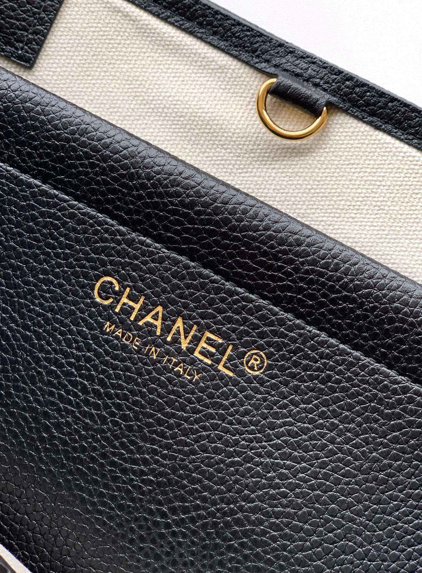 Black pebbled leather handbag interior with Chanel logo and Made in Italy text