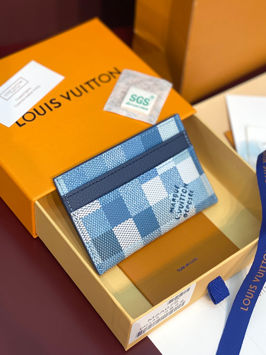 Louis Vuitton blue checkered card holder with navy border on gift box