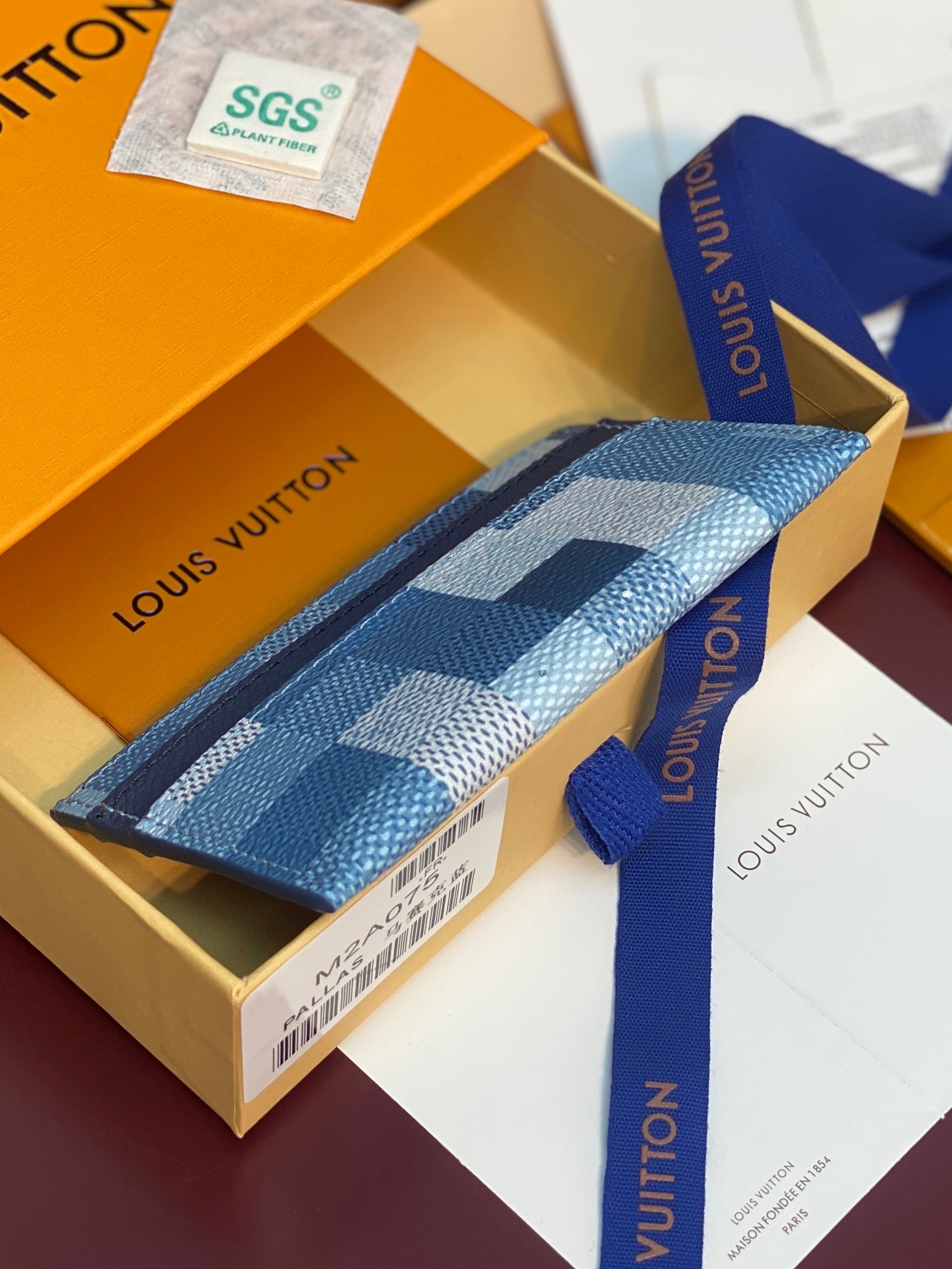Louis Vuitton blue checkered card holder with navy border and ribbon