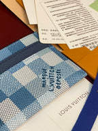 Louis Vuitton blue checkered card holder with logo print and navy top strip