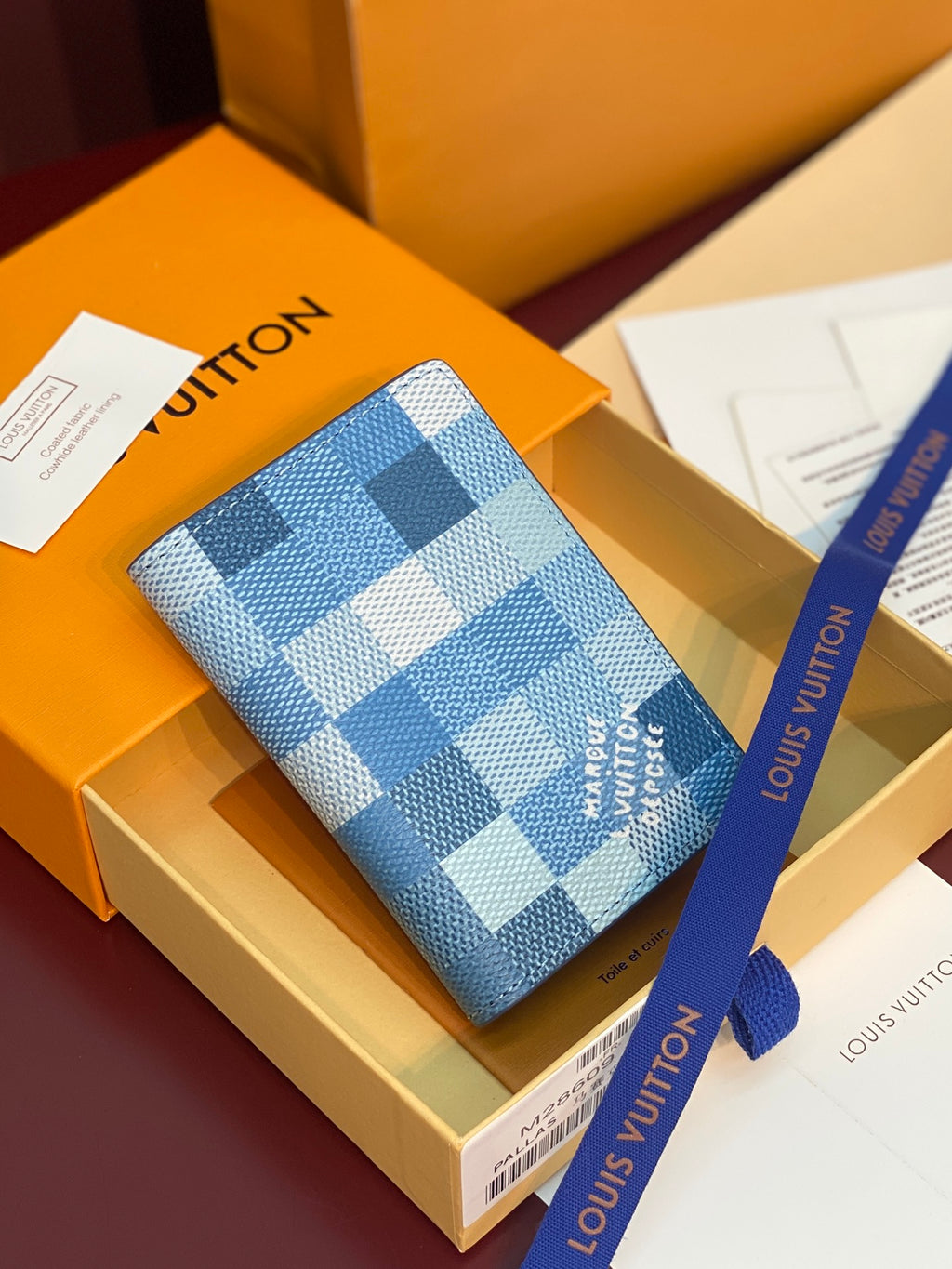 Blue checkered leather card holder with several card slots