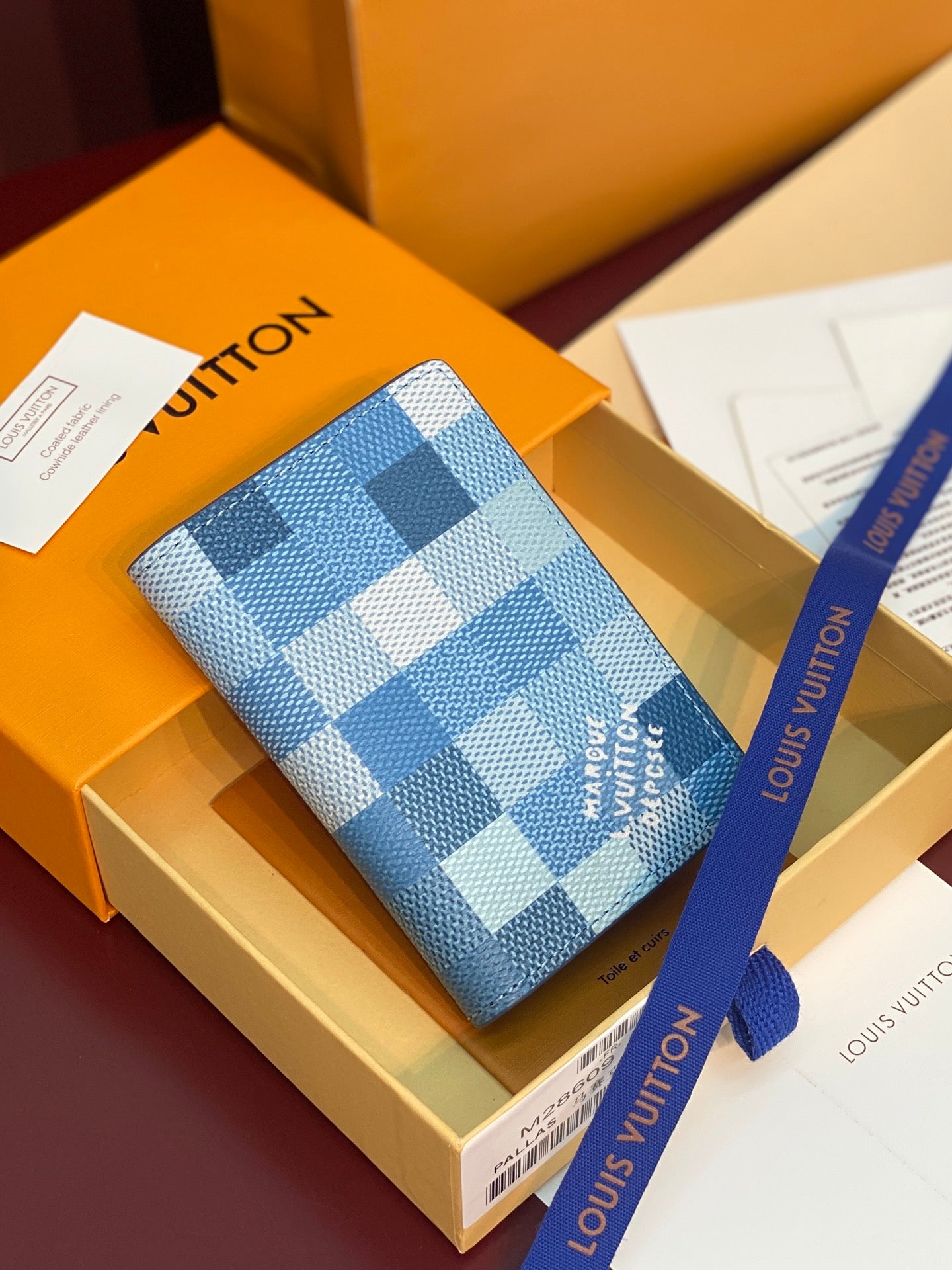 Blue checkered leather card holder with several card slots