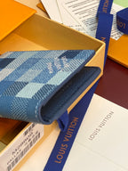 Blue checkered leather card holder side view with navy trim
