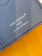 Close-up of blue leather card holder with Louis Vuitton Paris made in France