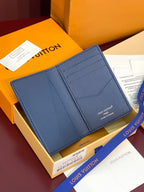 Blue textured leather card holder with front pocket and stitched edge