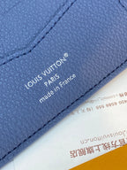 Louis Vuitton small wallet close-up, blue embossed logo with “made in France”