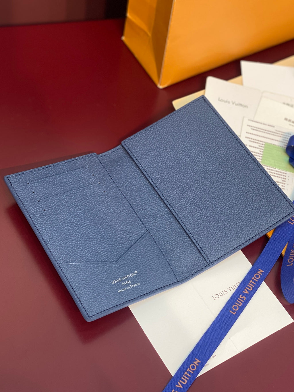 Louis Vuitton blue grained leather wallet-style bag with open interior pockets
