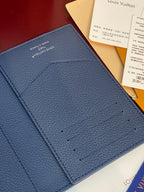 Louis Vuitton blue grained leather wallet-style bag, close-up of front logo area