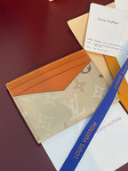 Louis Vuitton monogram card holder, beige exterior with tan card slot pocket.