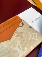 Louis Vuitton small card holder close-up of beige monogram canvas corner and tan panel